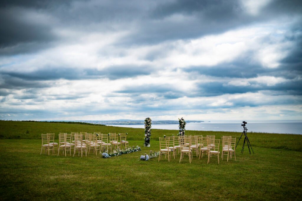 the outdoor wedding ceremony with coastal veiws