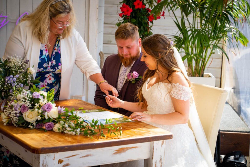 bride and groom signing