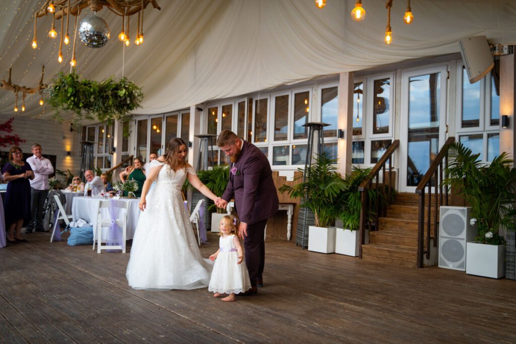 Bride and Groom plus flower girl dancing