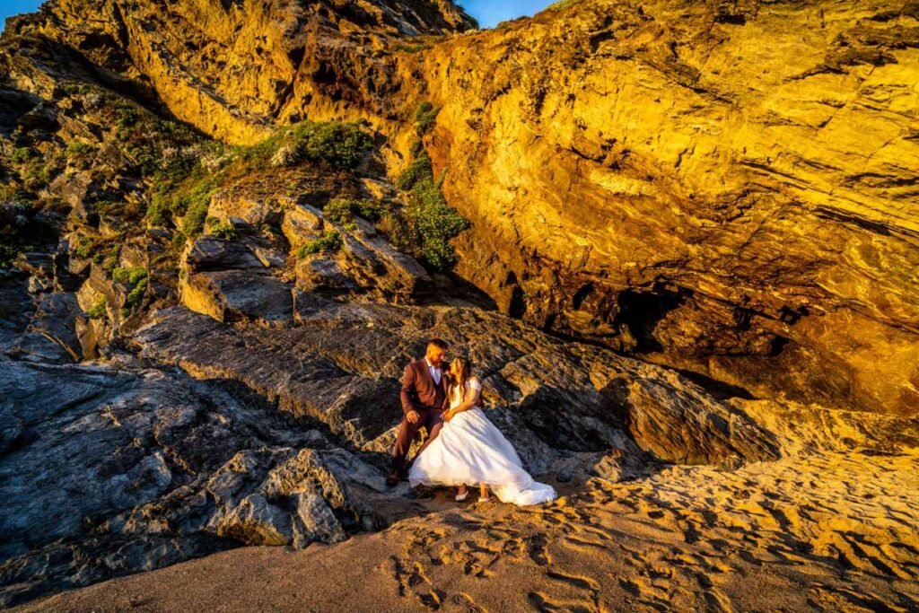 Bride and Groom sitting on the rocks