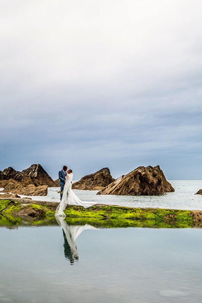 Bride and Groom reflected in the sea pool