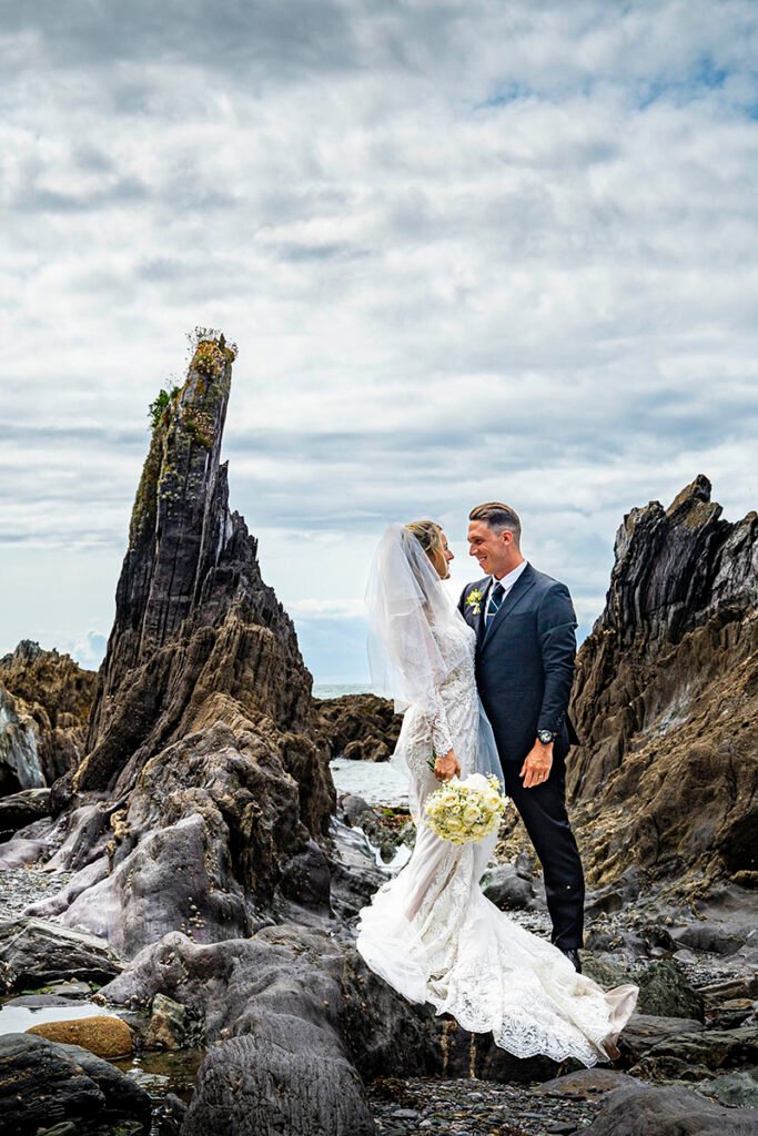 Bride and Groom on on a rock at the beach