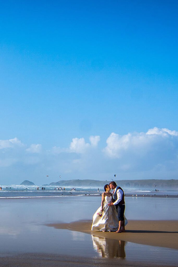 Bride and Groom reflected in the sand on the beach