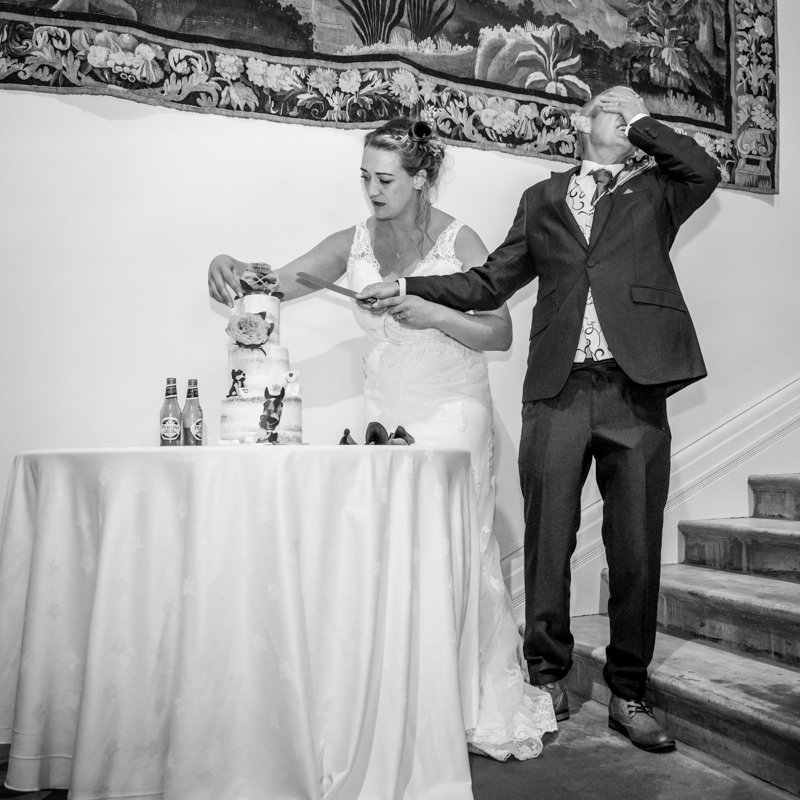 Bride and Groom cutting the wedding cake B&W