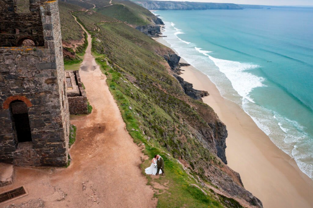 wheal coates cornwall drone image of bride and groom on the coast path