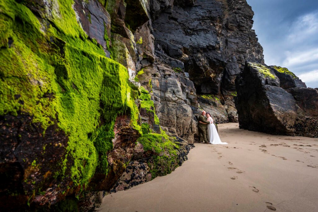 Bride and Groom by the cliffs on Chapel Porth beach cornwall
