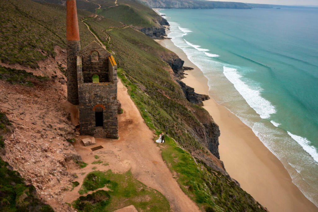 Bride and Groom on the coastpath cornwall taken from a drone