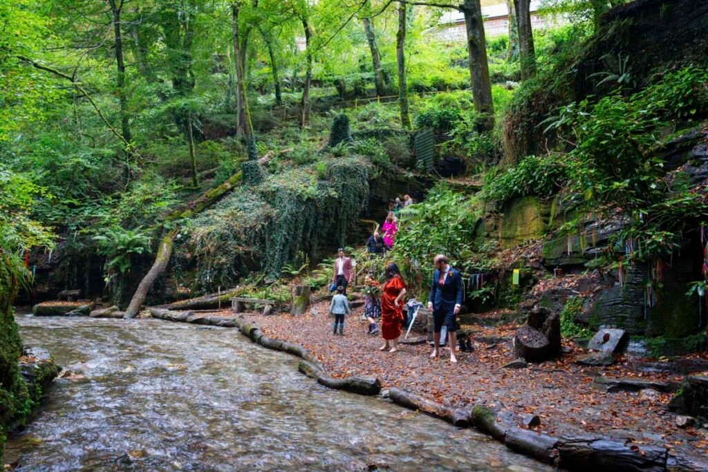 wedding party walking down to a stream