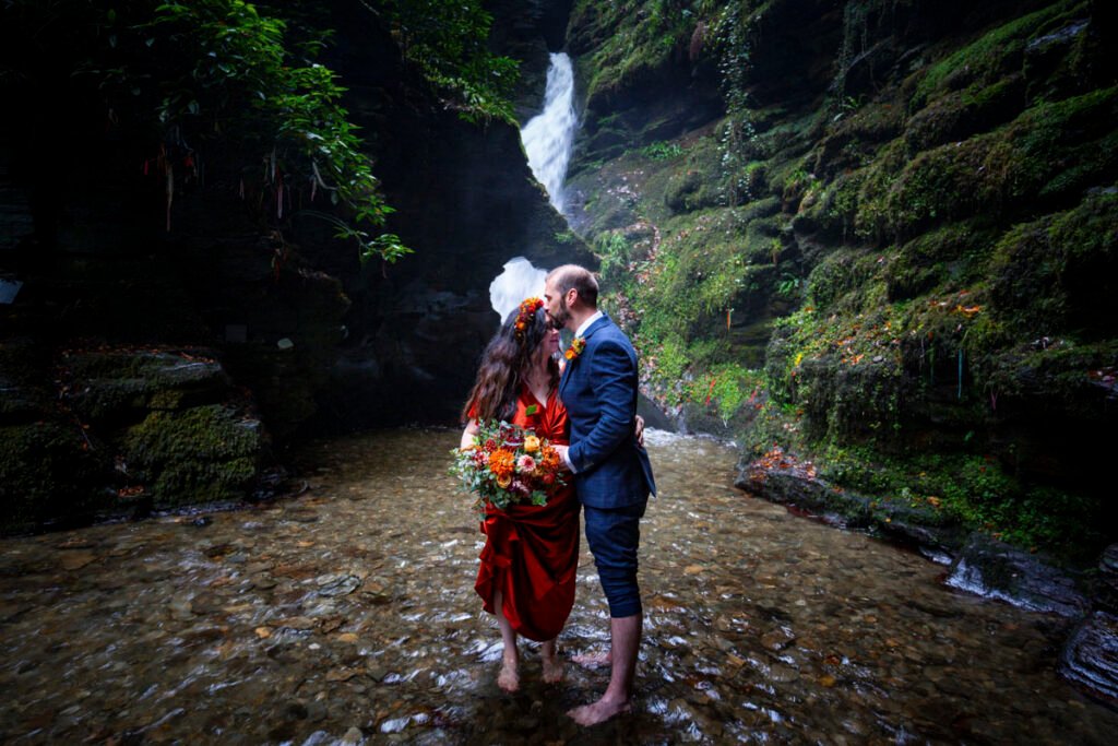Bride and Groom by a stream and waterfall