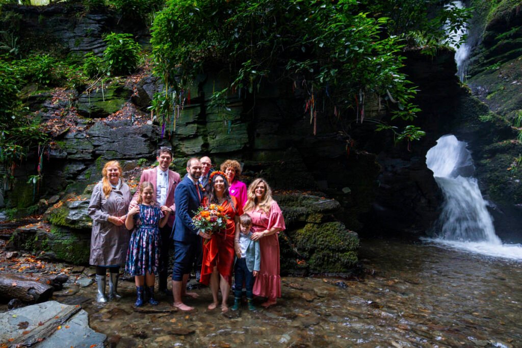 wedding party by a waterfall