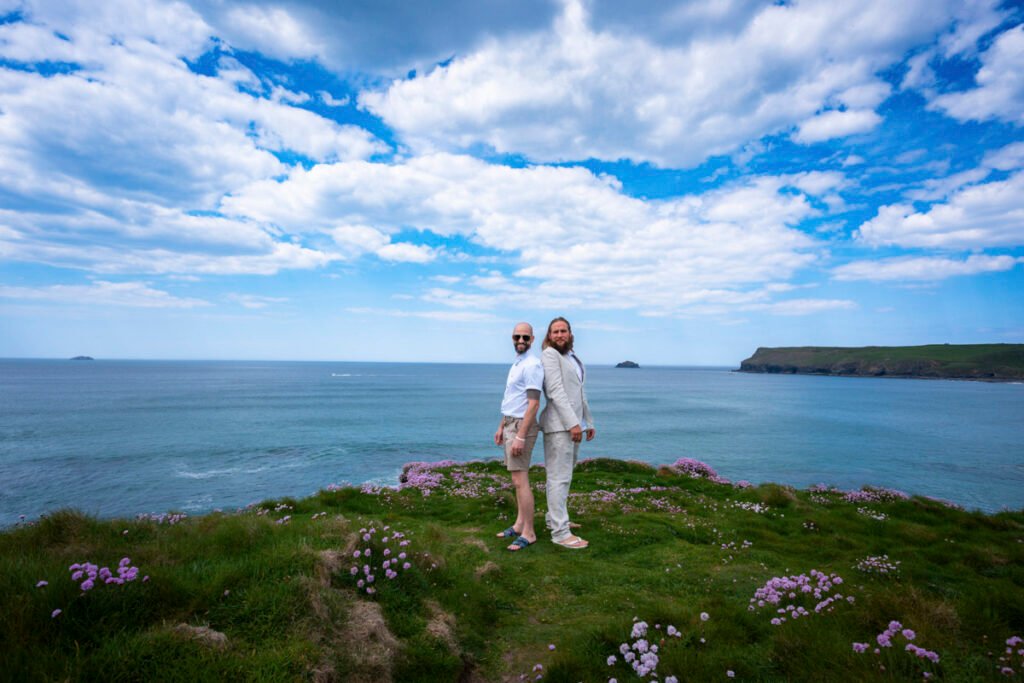 Groom and best man at the wedding ceremony on the cliff top overlooking the beach