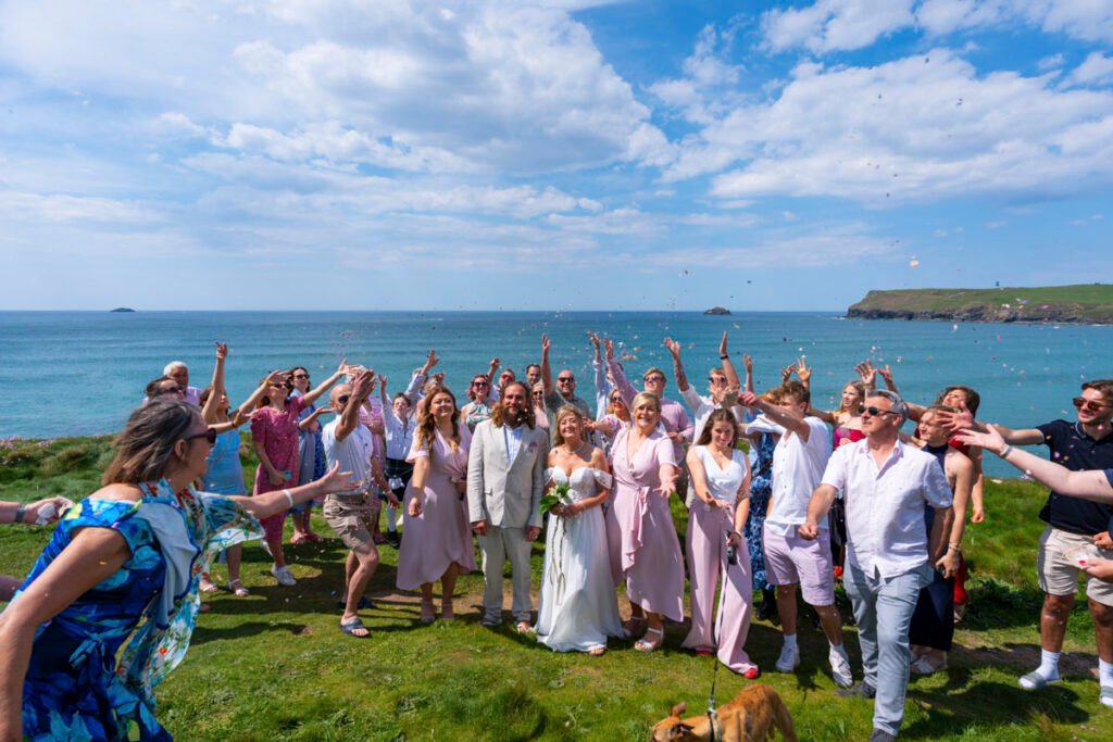 Bride and Groom confetti shot on the cliff top overlooking the beach