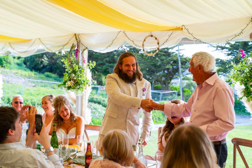 Groom and father of the bride shaking hands