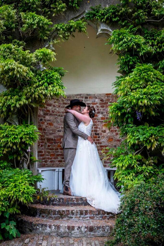 Bride and Groom kissing in th garden
