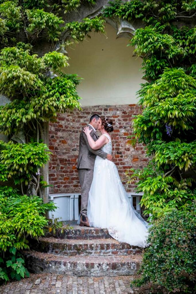Bride and Groom kissing in th garden