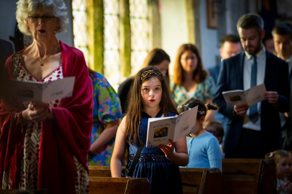 Flower girl singing during the ceremony