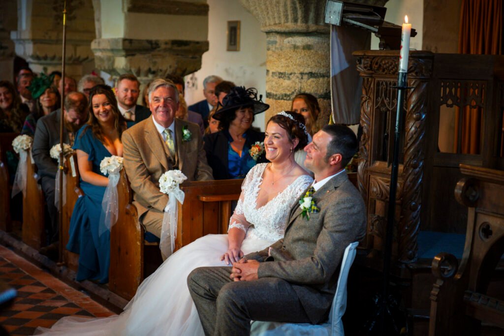 Bride and Groom listening to the sermon during the ceremony