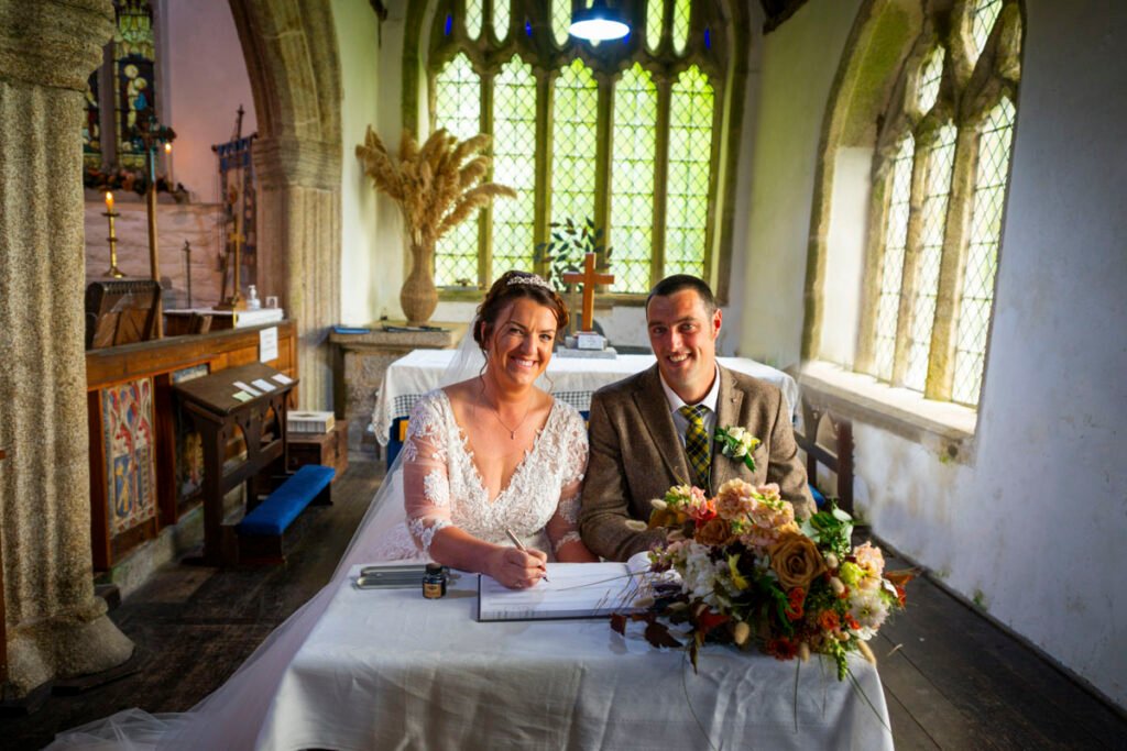 Bride and Groom signing the register