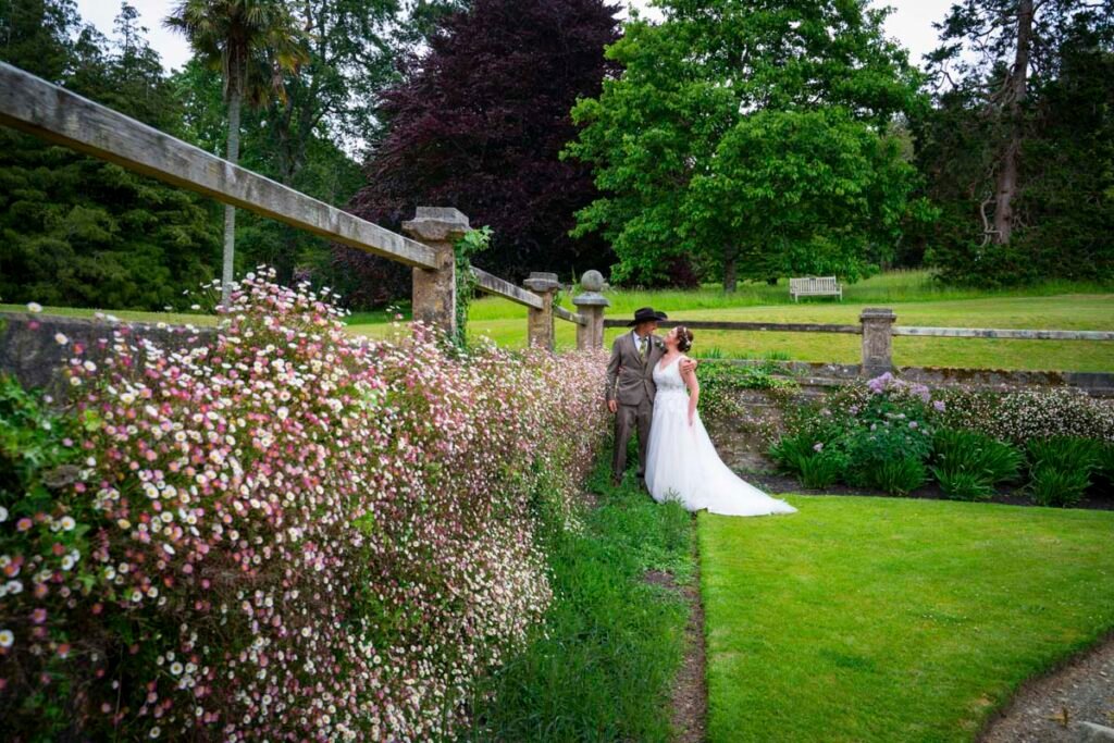 Bride and groom posing in the garden