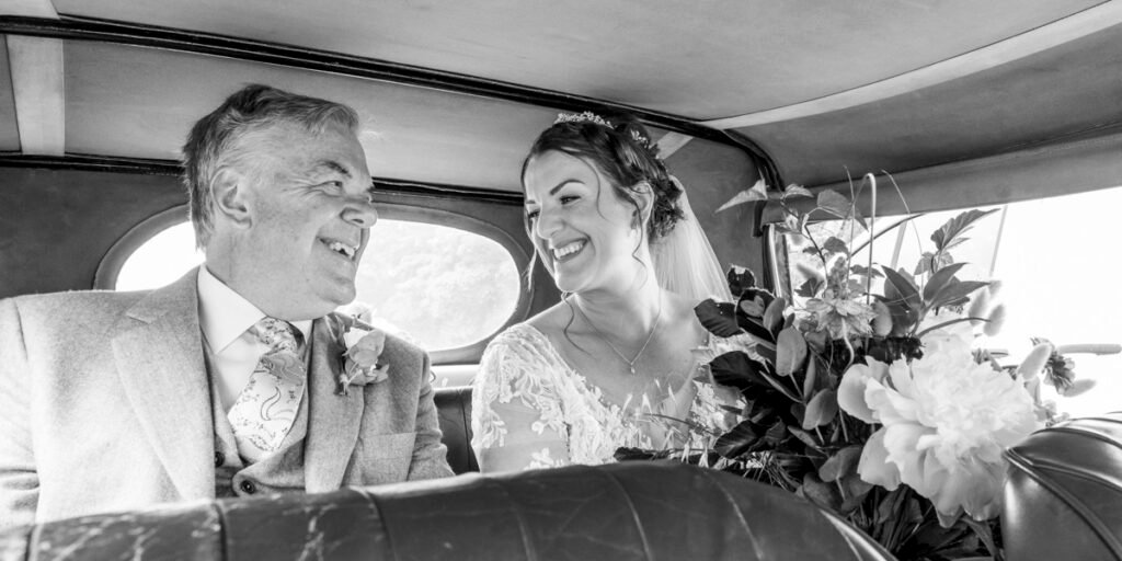 Bride and Father of the Bride in the wedding car B&W