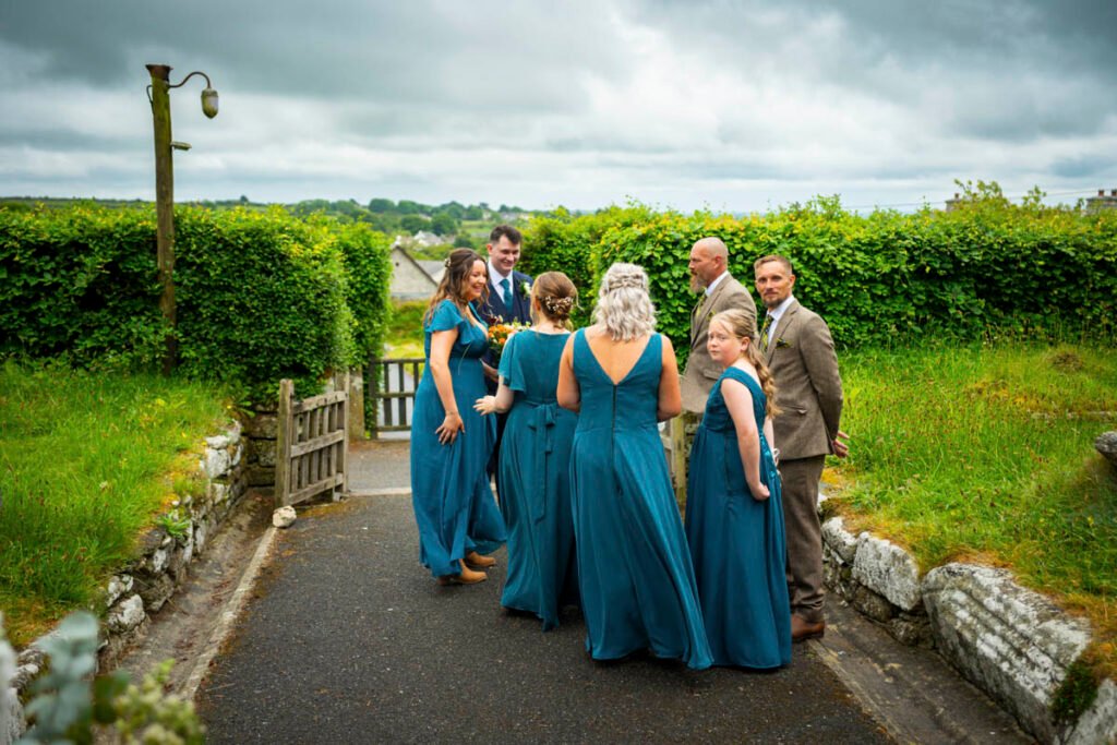 Bridesmaids and groomsmen waiting outside the church